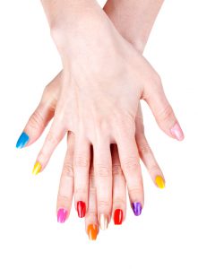 Women's hands with a colored nail polish (manicure). Isolate on white